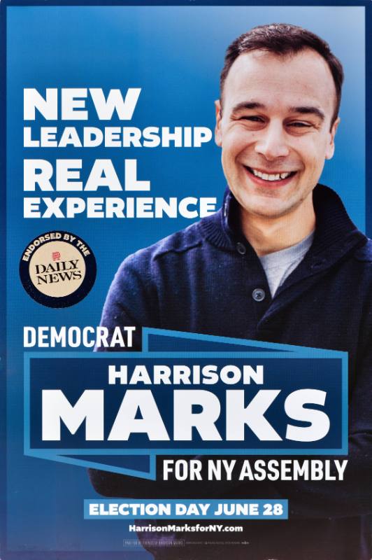 A poster of a smiling white man on a dark blue background.