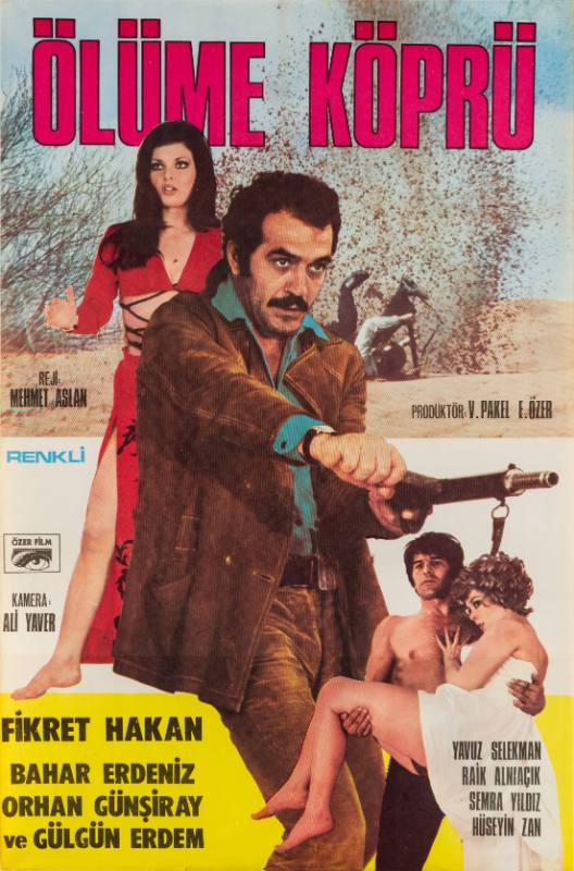 A poster of a man aiming a machine gun in front of a woman in red above a man carrying a woman.