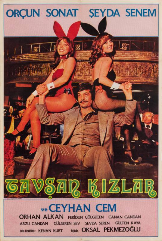 A poster of a man in a suit with women dressed as a Playboy bunny sitting on each shoulder.