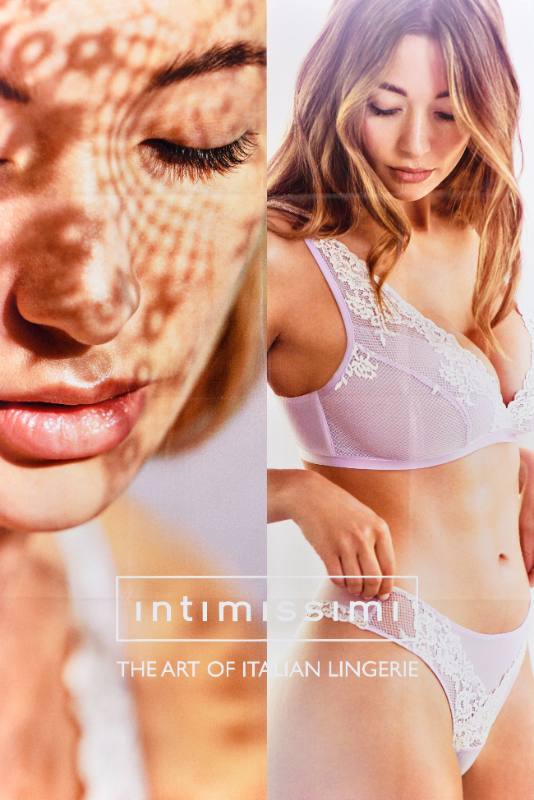 A poster of a thin white woman wearing pink lacy underwear.