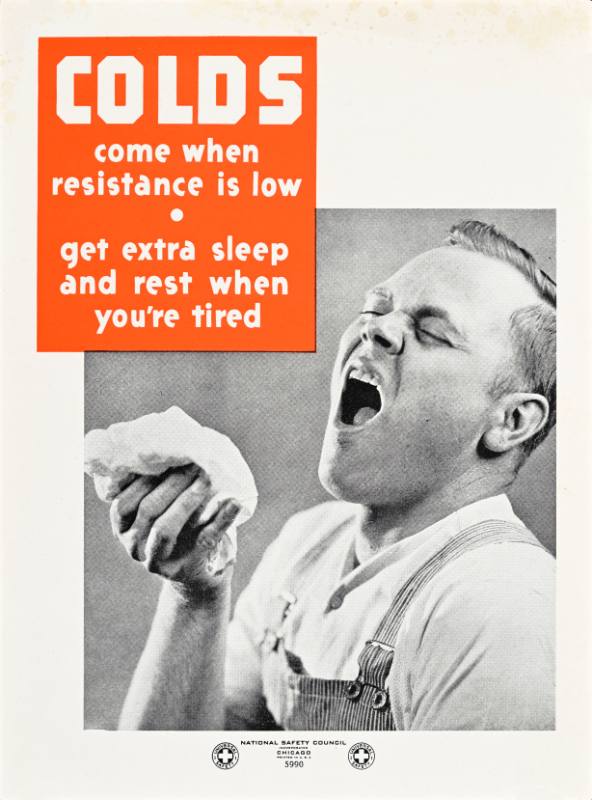 A black and white photographic poster of a man in coveralls sneezing into a handkerchief.