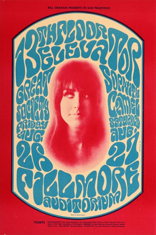 A psychedelic poster of a white woman's face surrounded by blue text