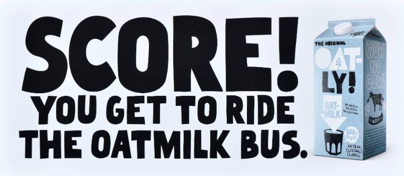 A poster with black text on a white background next to a carton of oatmilk