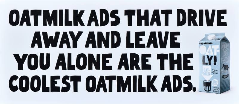 A poster with black text on a white background next to a carton of oatmilk