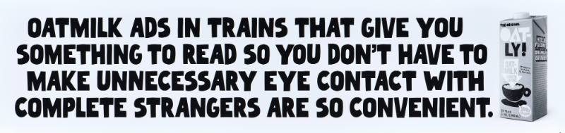 A poster with black text on a white background next to a carton of oatmilk