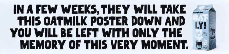 A poster with black text on a white background next to a carton of oatmilk