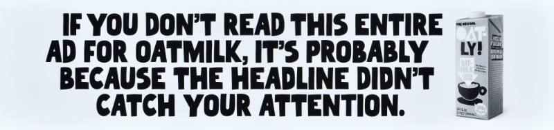 A poster with black text on a white background next to a carton of oatmilk