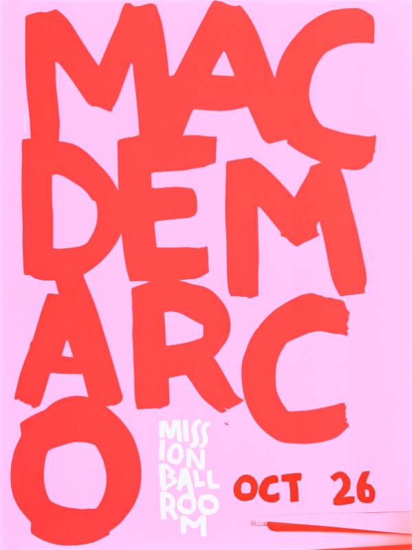 A poster of large painted red text on a pink background