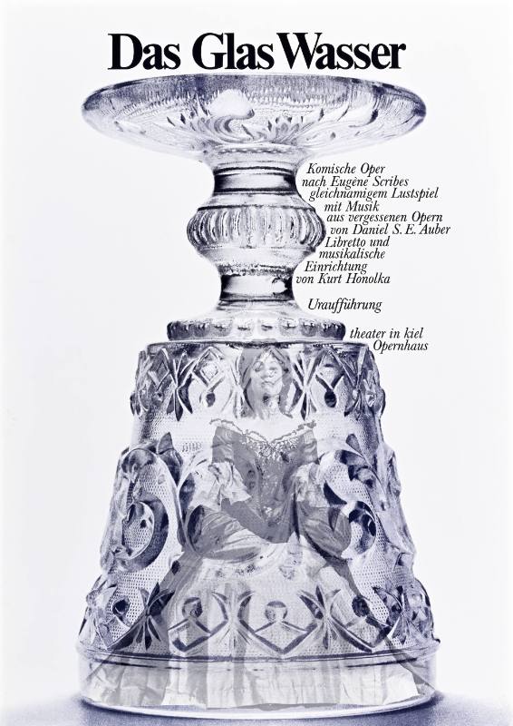 A poster of an ornate crystal glass with images of a woman inside of it