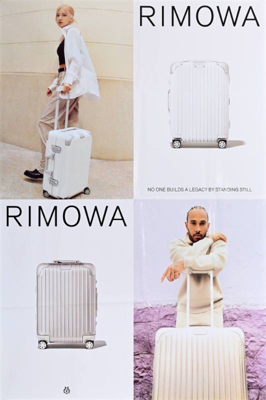 A poster of a man and a woman with a suitcase