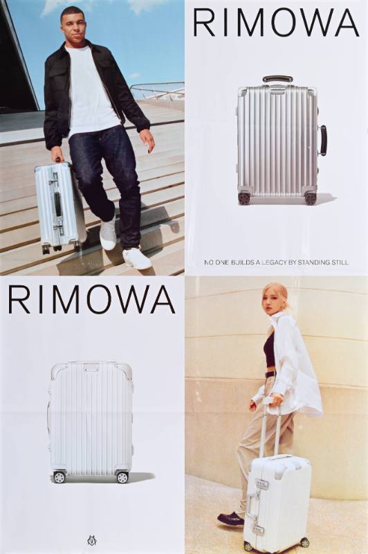 A poster of a man and a woman with a suitcase