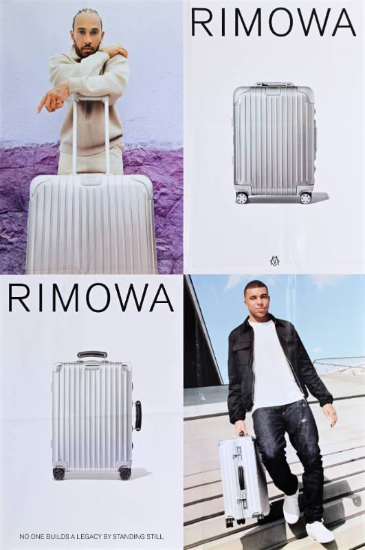 A poster of two men with a suitcase