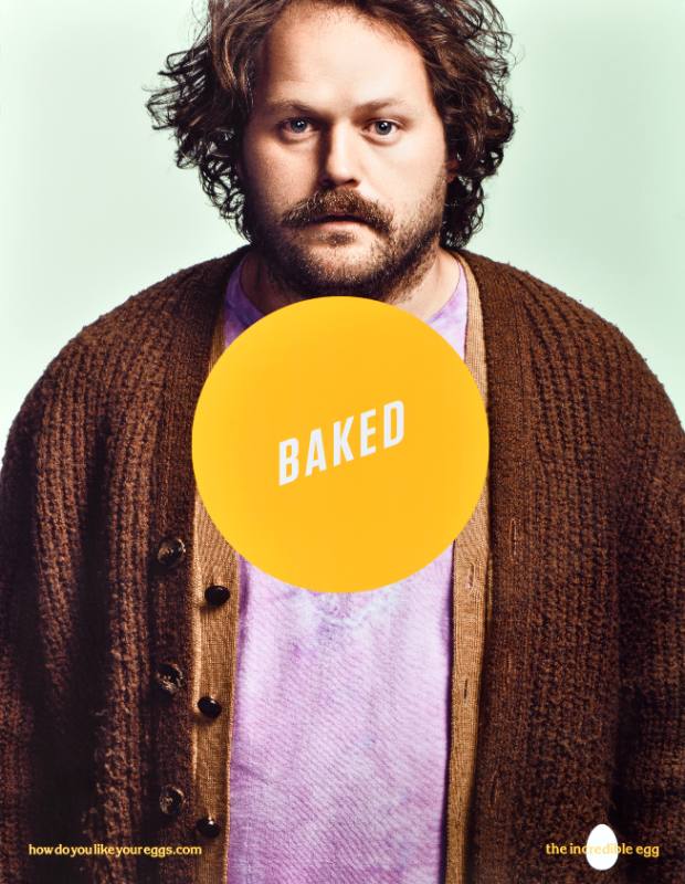 A poster of a white man with a hazy look on his face with a yellow circle at his middle