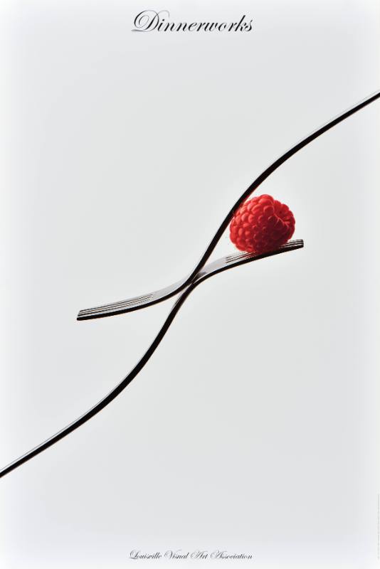 A poster of a raspberry balancing on two forks on a white background