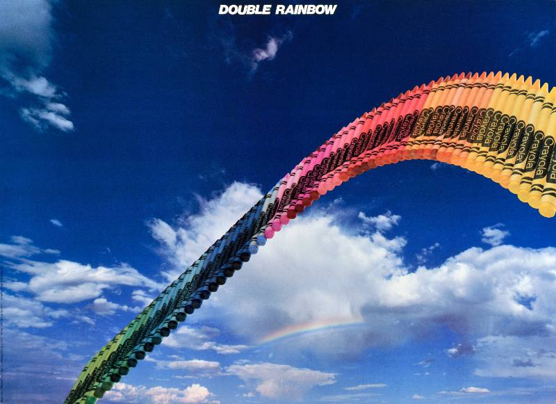 A poster of a rainbow made out of crayons on a blue sky background