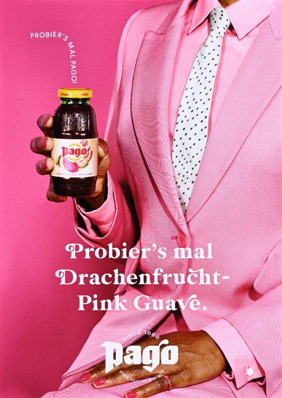 A poster of a person in a pink suit holding a bottle of pink juice