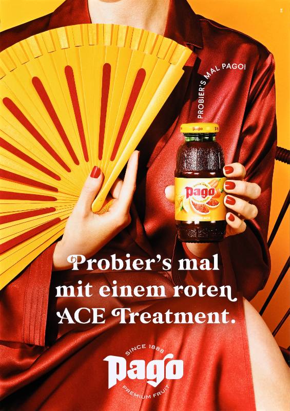 A poster of a woman with light skin and a fan holding a bottle of red juice