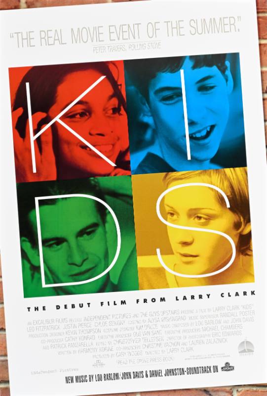 A poster of four young people's faces printed in red, yellow, blue, and green.