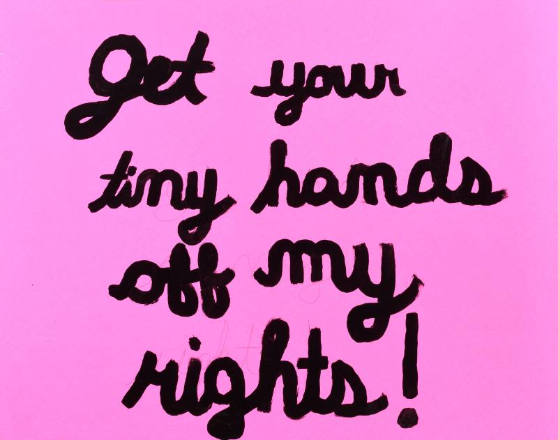 A pink text based poster with black cursive text