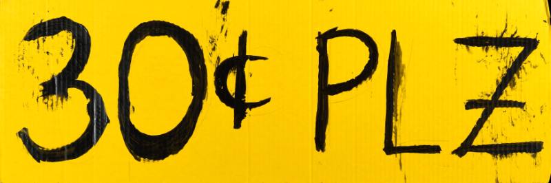 A poster of black hand painted text on a yellow background