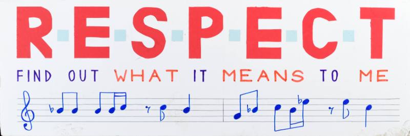 A poster of red text above sheet music on a white background