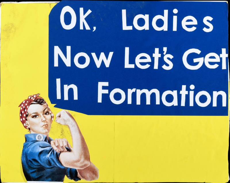 A poster of a white woman flexing on a yellow and blue background