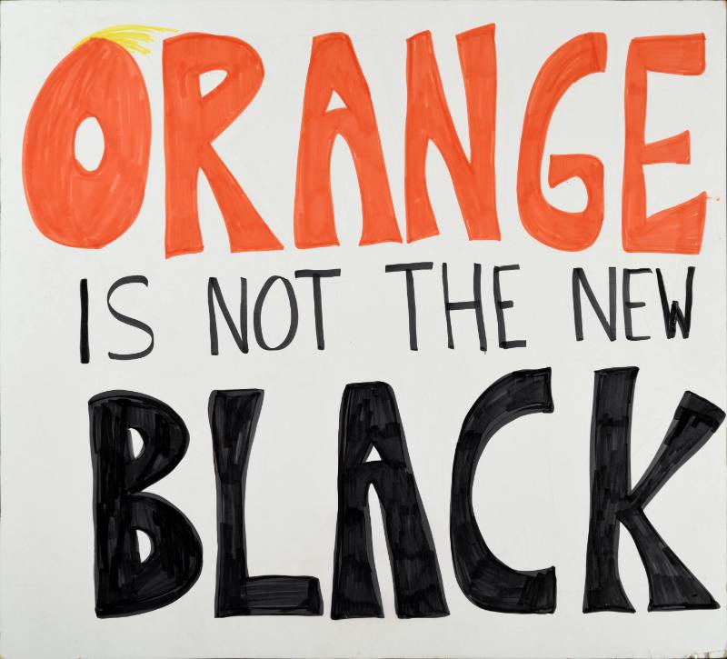 A white text based poster with orange and black text