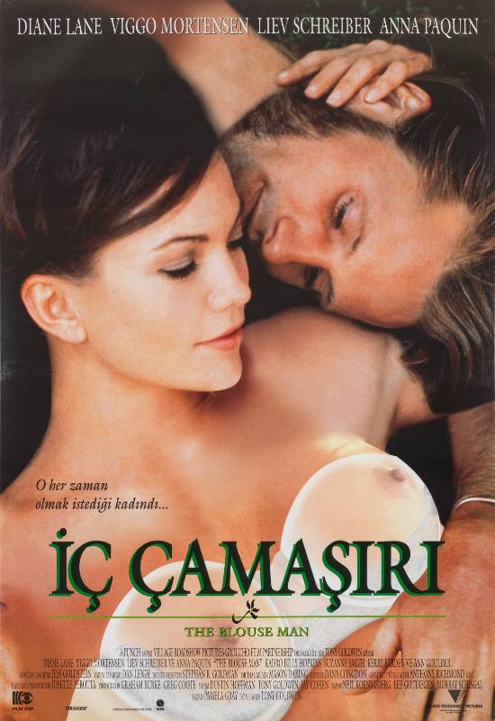 A photographic poster of a woman in a see through top stroking the head of a man lying next to her.