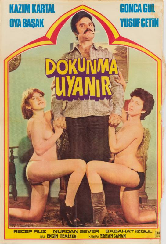A poster of a mustachioed man smoking a cigarette flanked by two topless women in a chapel outline.