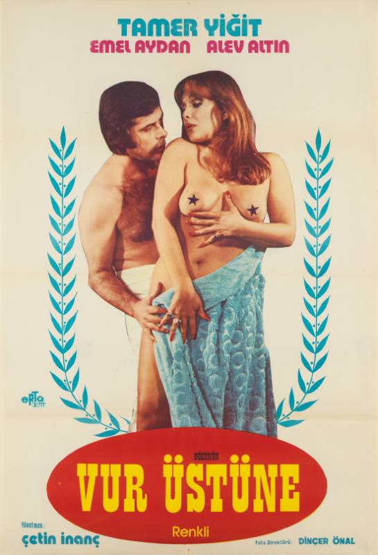 A poster of a topless couple, a man holding a woman from behind, wearing just towels.