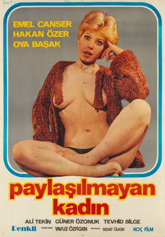 A poster of a topless woman sitting cross-legged wearing an open knit sweater.