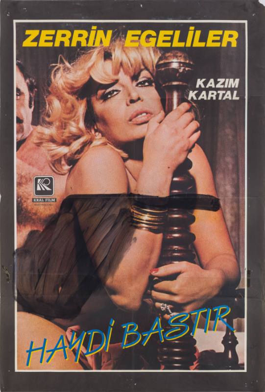 A poster of a blonde woman leaning against a bed post covered in black marker in front of a man.